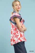 Floral flutter top, side view, pink-and-white print with red flowers and navy trim