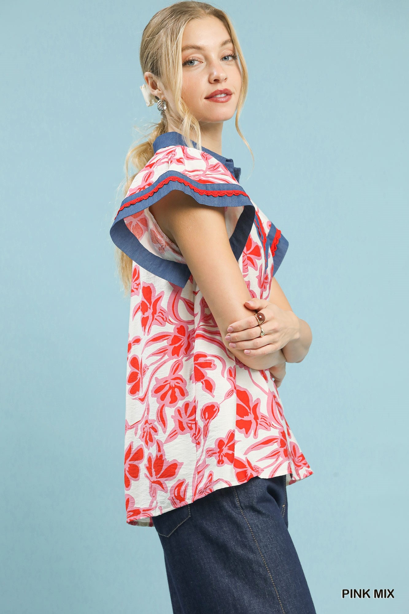 Floral flutter top, side view, pink-and-white print with red flowers and navy trim