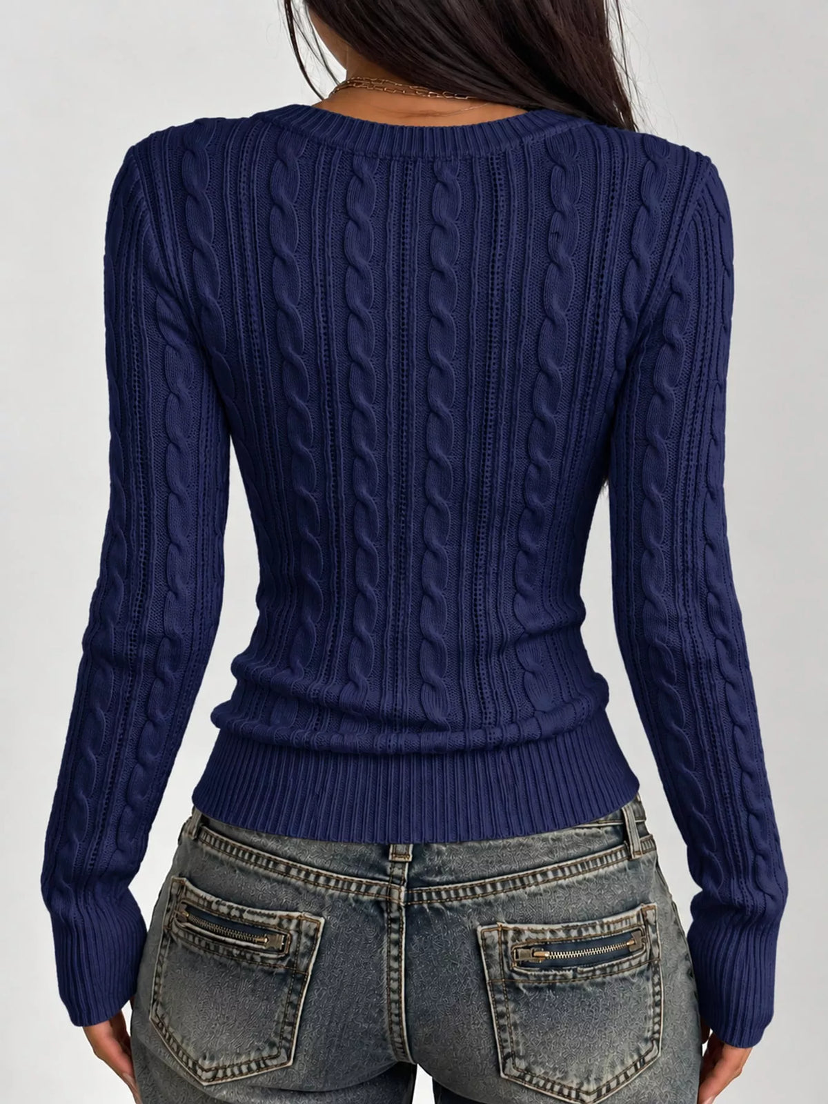 Navy cable-knit sweater back view with vertical cable texture and long sleeves