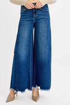 Women’s high-rise wide-leg jeans in blue wash denim, front raw frayed hems