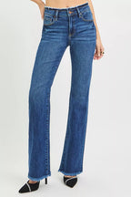 Women's mid-rise bootcut jeans in dark blue with frayed hem and front seams