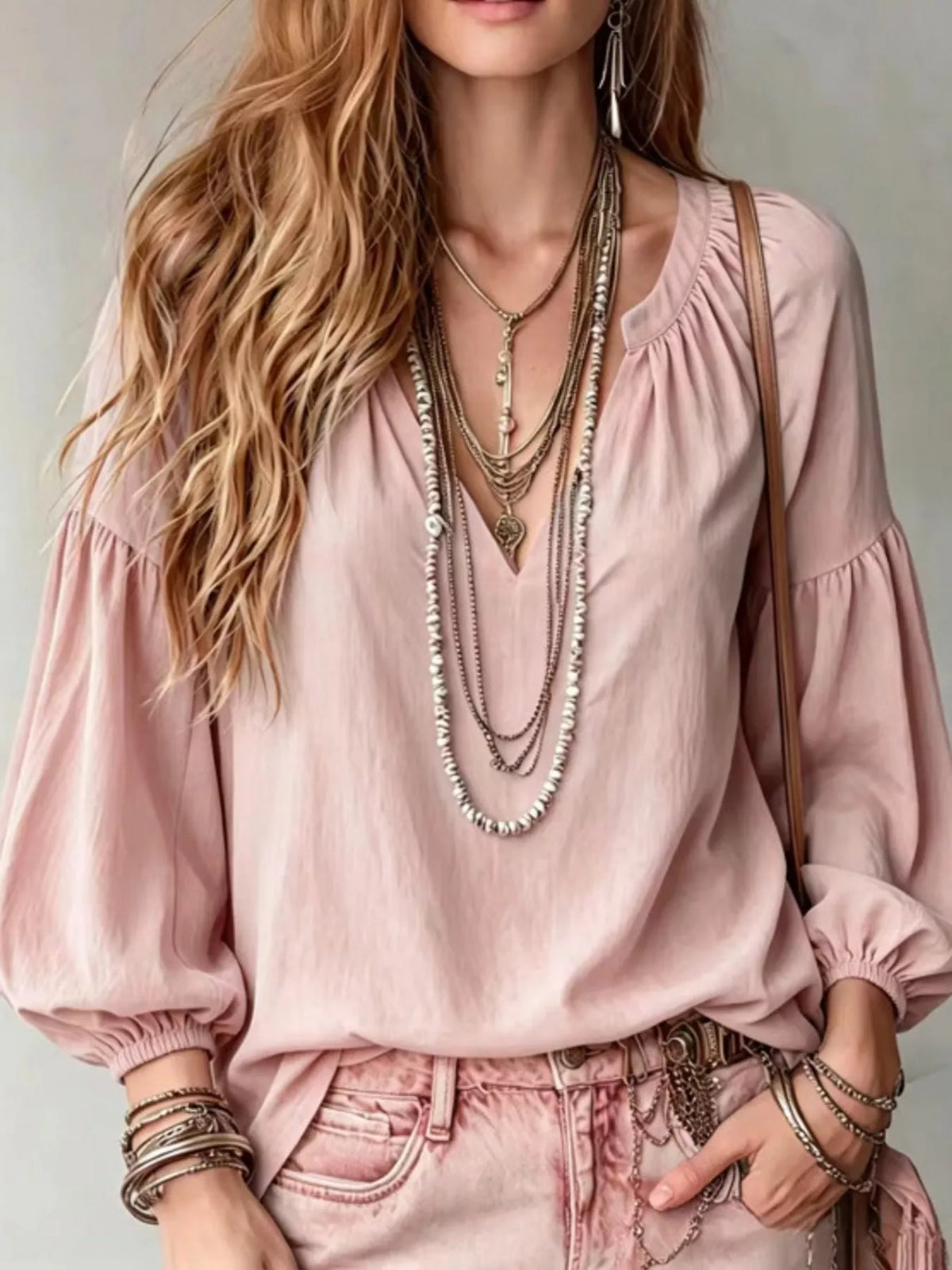 Blush pink notched V-neck blouse with gathered balloon sleeves and elastic cuffs