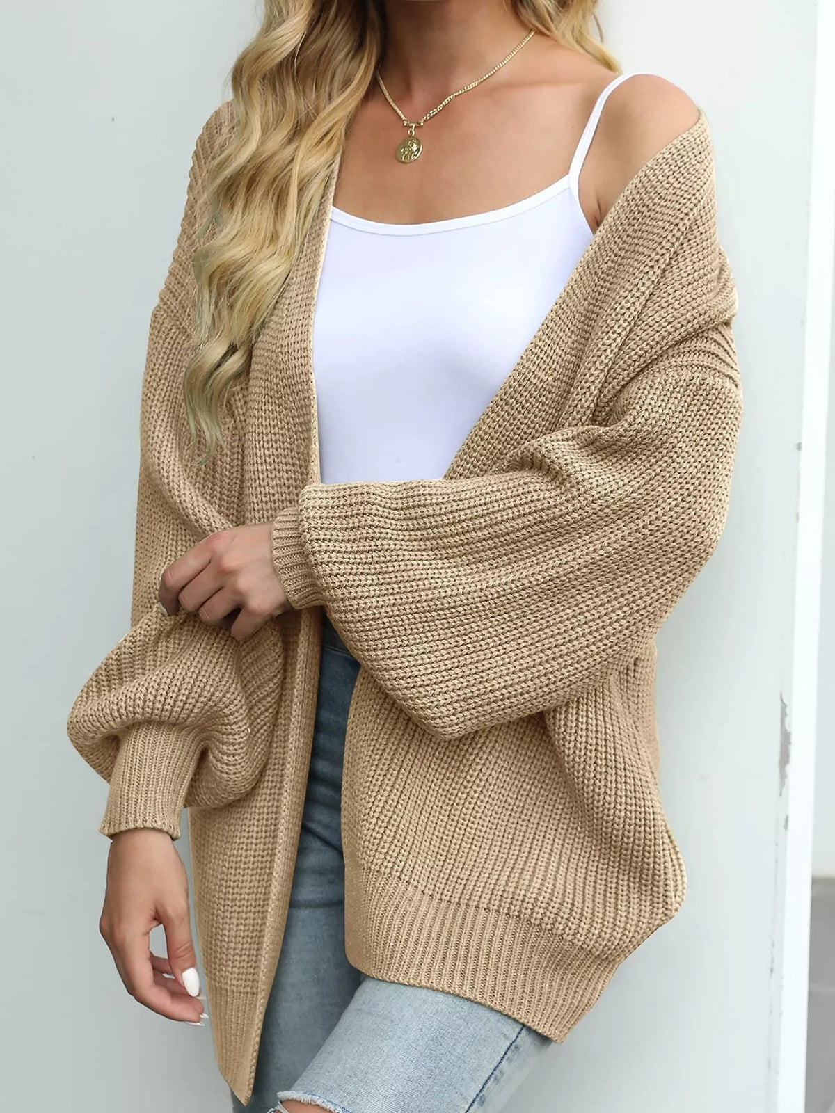 Chunky knit cardigan with lantern sleeves and open front, beige color.
