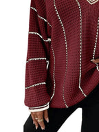 Burgundy textured knit sweater with cream striped sleeves and ribbed cuff and hem.