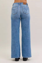 Light blue mid-rise wide-leg jeans with two back patch pockets and belt loops