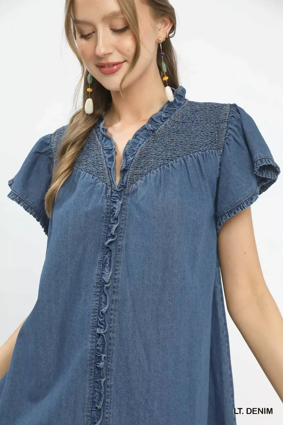 Washed denim ruffle dress close-up with button front and gathered yoke, cap sleeve