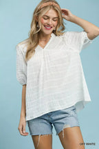 Off-white textured blouse with puff sleeves and scalloped V-neck