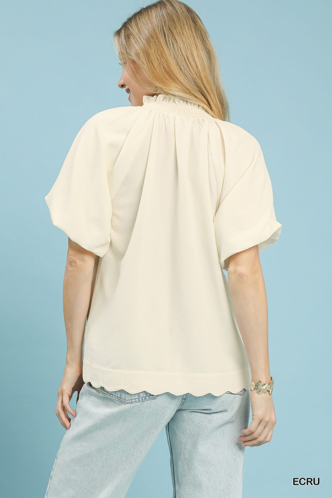 Ecru textured blouse, back view with pleated yoke and short puff sleeves