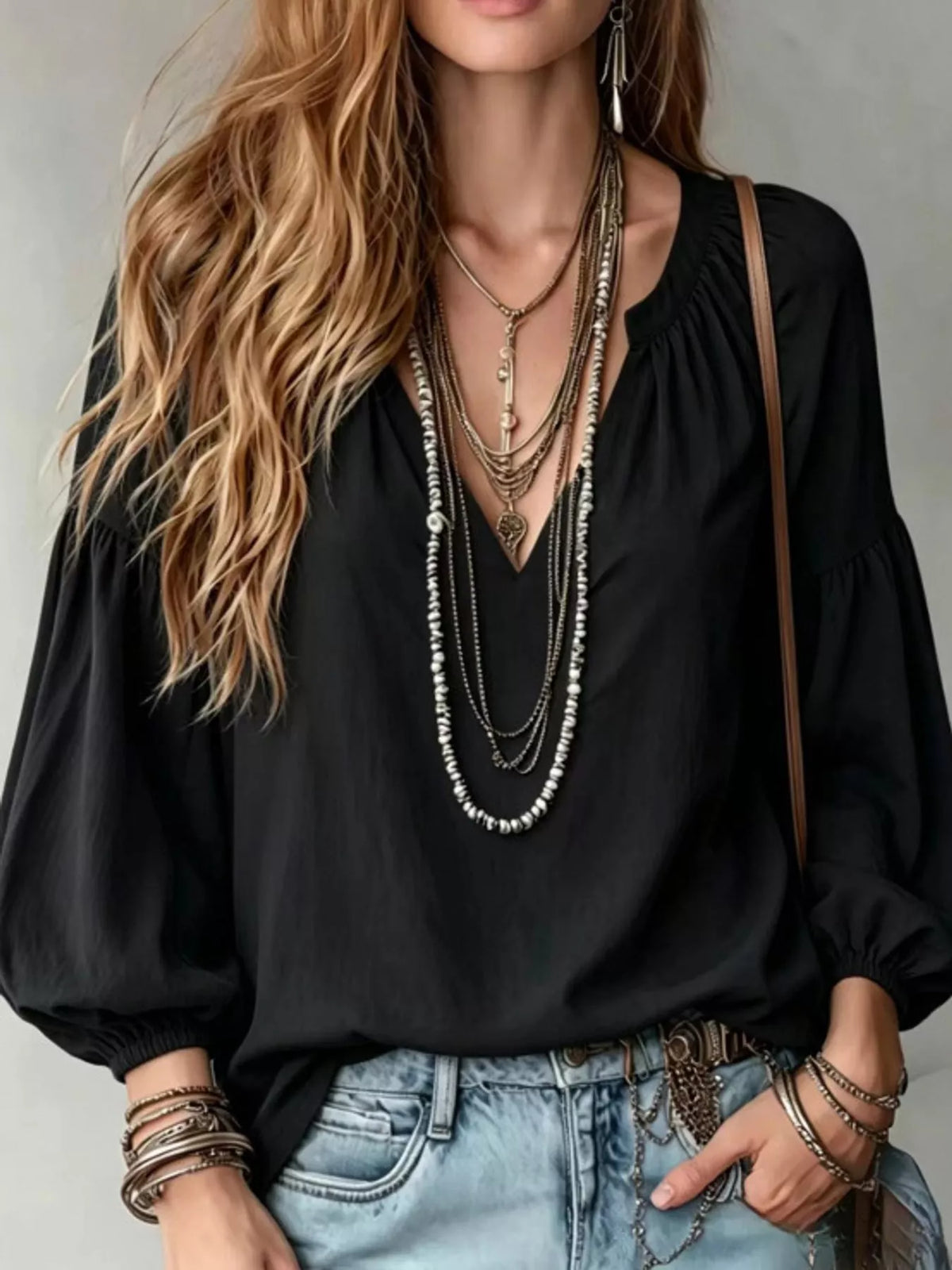 Black balloon-sleeve blouse with notched V-neck and elastic gathered cuffs
