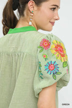 Light green top shoulder detail with embroidered floral puff sleeve