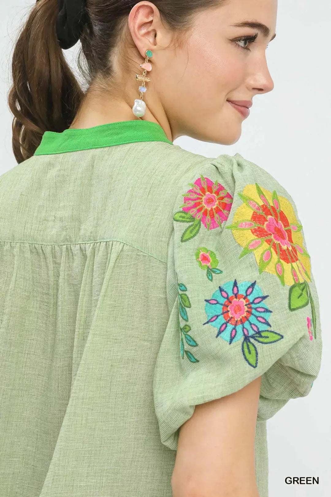 Light green top shoulder detail with embroidered floral puff sleeve