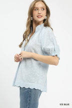 Ice blue pintuck ruffle blouse with short puff sleeves and scalloped hem