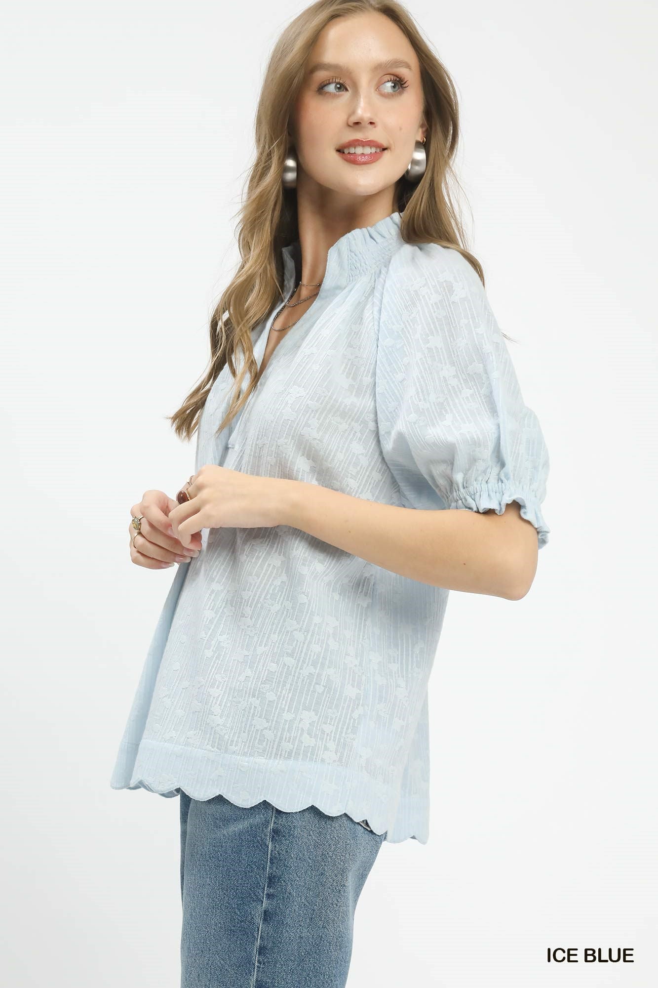 Ice blue pintuck ruffle blouse with short puff sleeves and scalloped hem