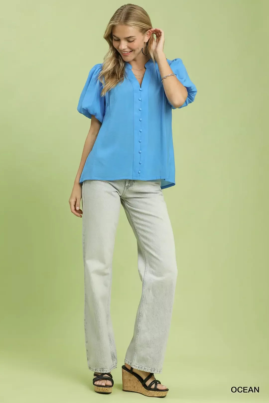 Ocean blue button-down puff sleeve shirt with front buttons, worn with light pants