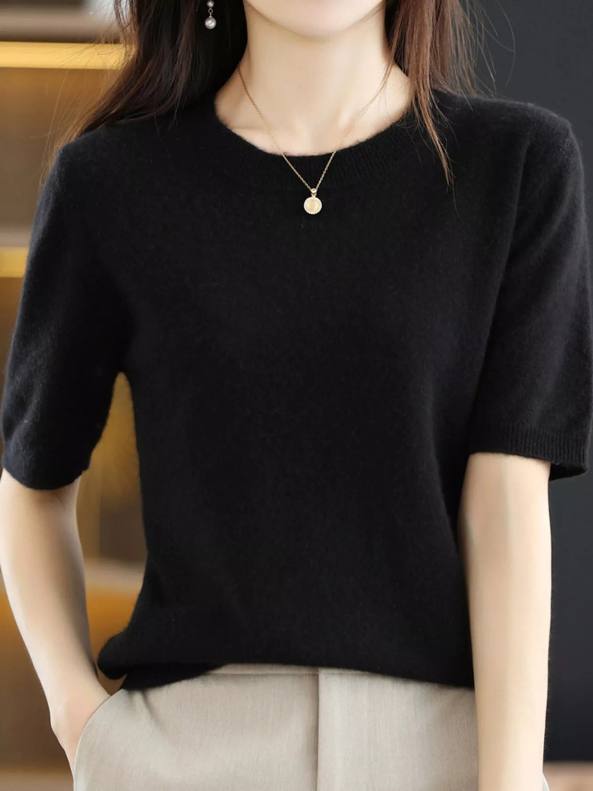 Black round-neck short-sleeve knit sweater with ribbed collar and cuffs