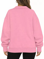 Pink oversized zip-neck sweatshirt, back view with ribbed hem and relaxed fit