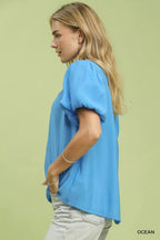 Ocean blue button-down puff sleeve shirt with short sleeves and curved front hem