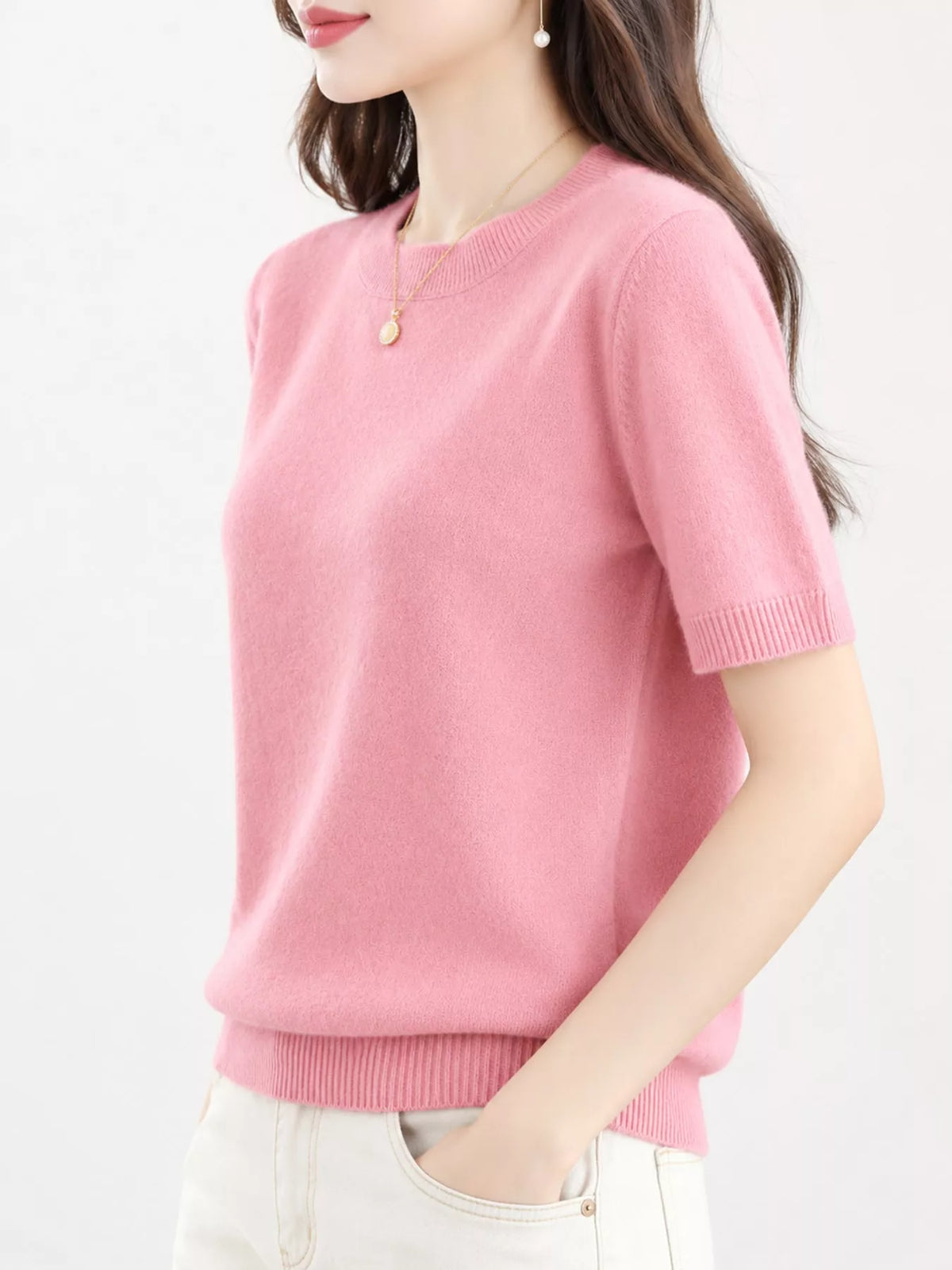 Pink round-neck short-sleeve sweater with ribbed neckline, hem, and cuffs