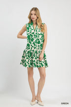 Green sleeveless tiered mini dress with white floral print and flared skirt