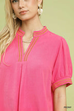 Embroidered V-neck linen blouse in peony pink, decorative trim at neckline