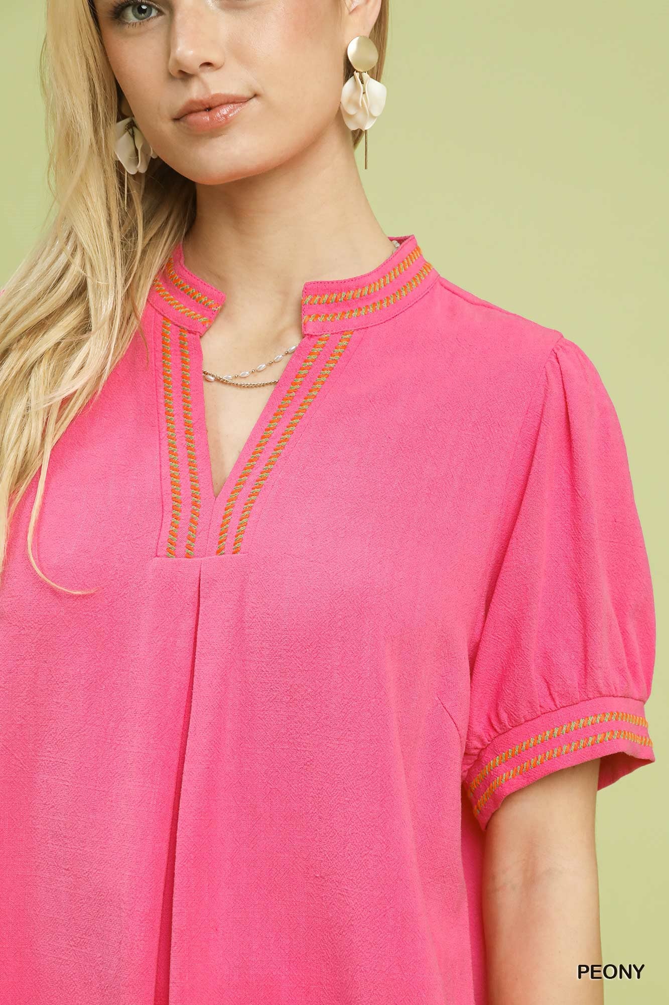 Embroidered V-neck linen blouse in peony pink, decorative trim at neckline