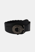 Black wide elastic belt with large ornate round buckle and side keeper loops.