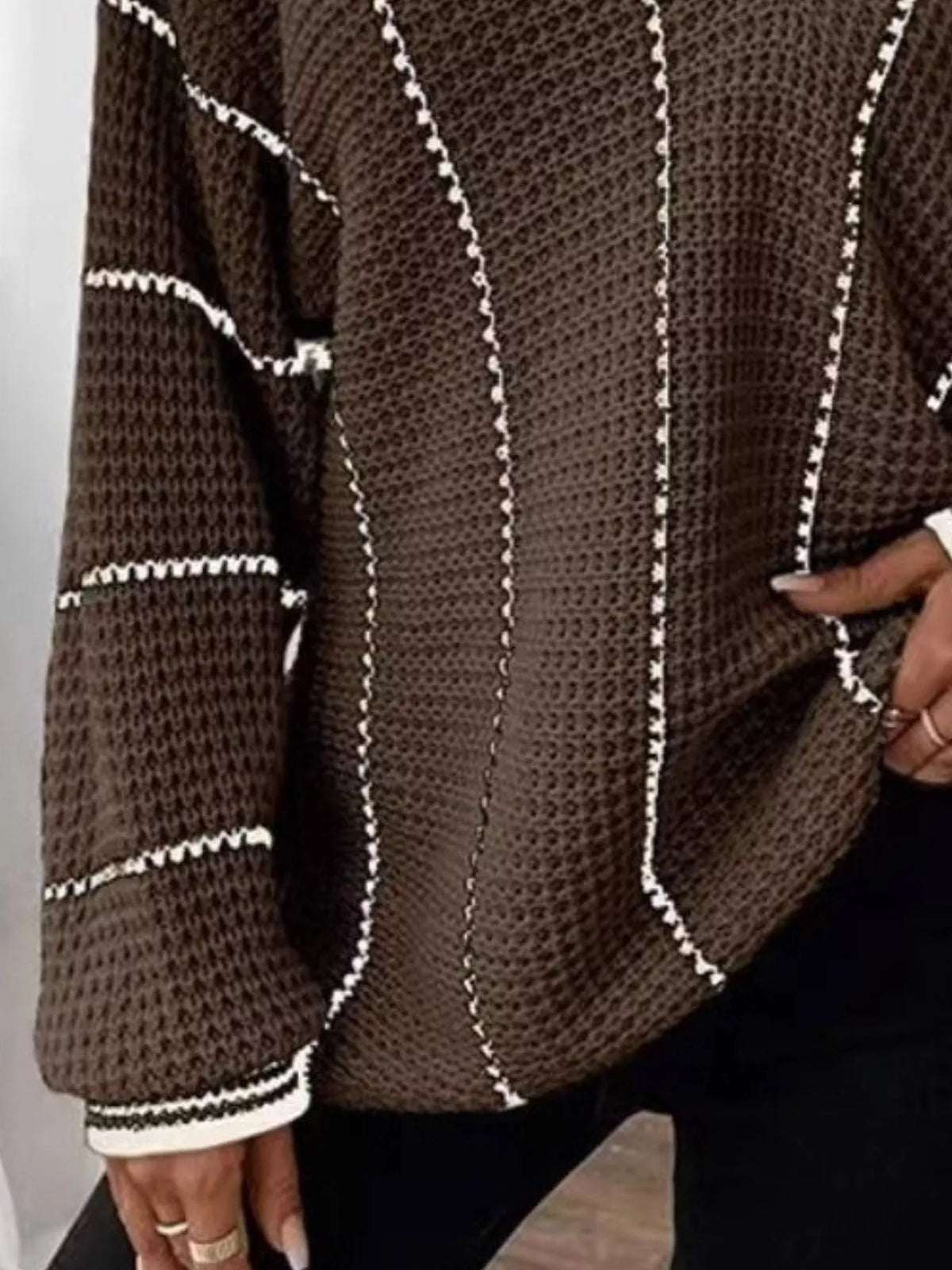 Brown V-neck textured knit sweater with white vertical stripe paneling and ribbed hem