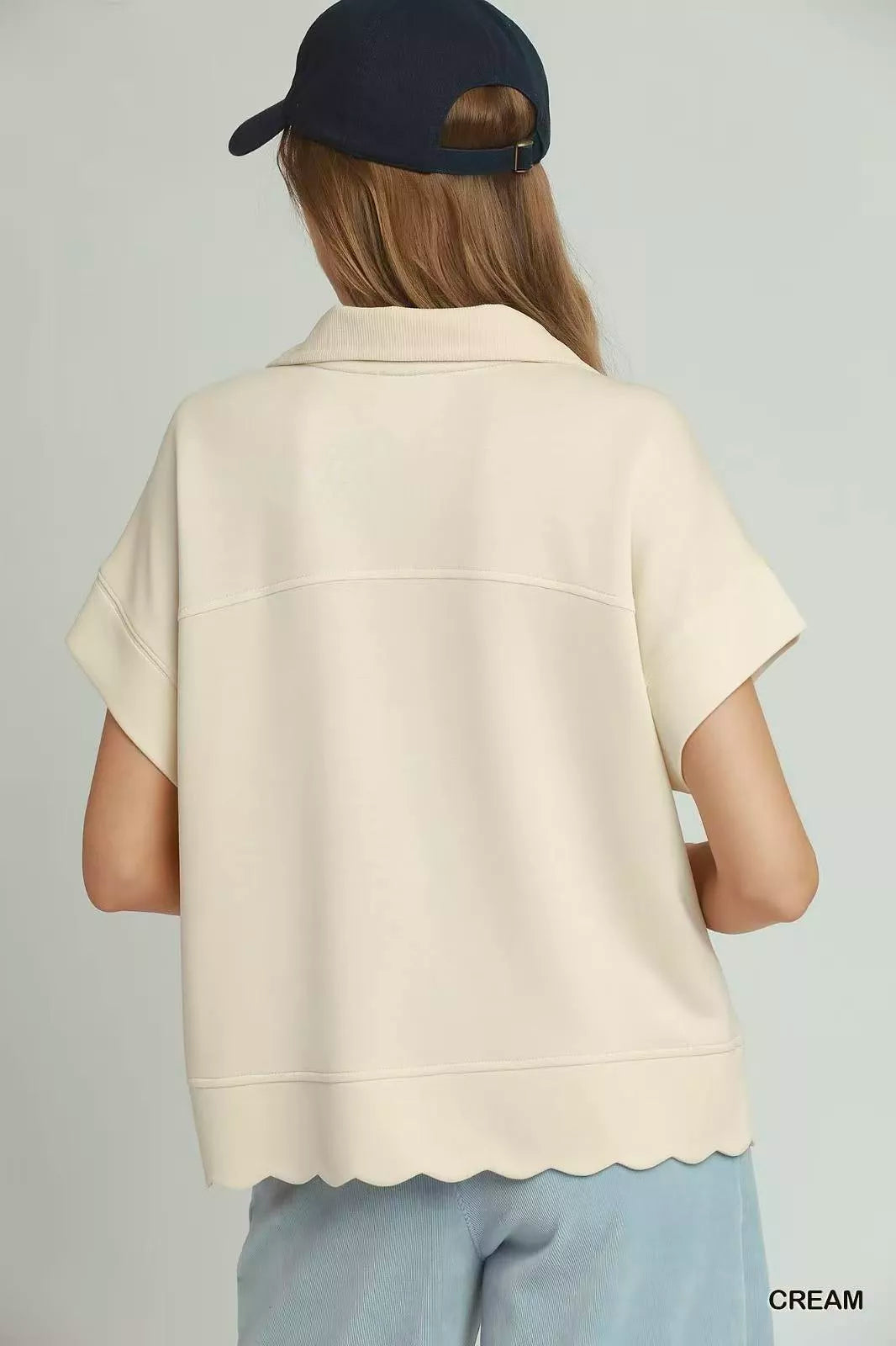 Cream half-zip pullover, back view, scalloped hem and short sleeves