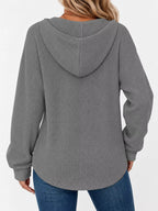 Back view of gray waffle-knit button hoodie with hood and drawstring ties