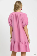 Pink babydoll dress, back view, with puff sleeves and ruffle tier hem