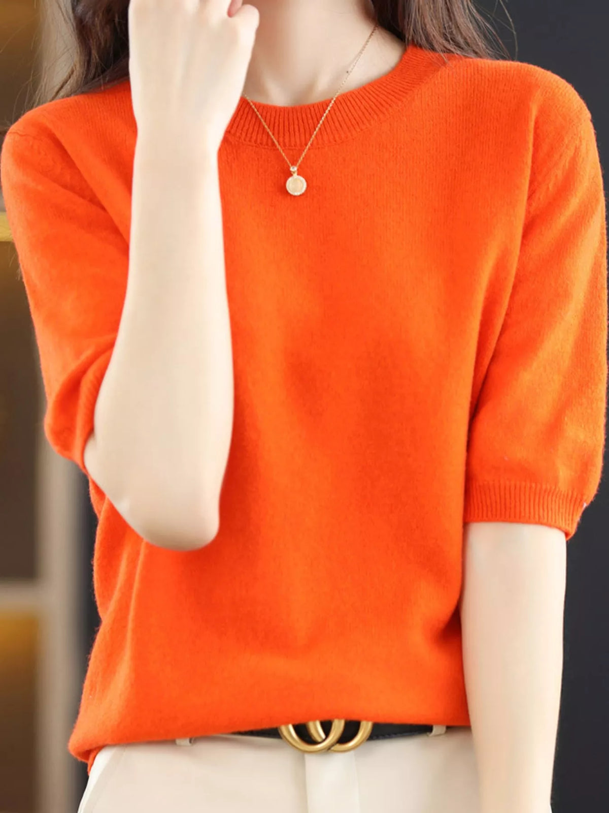 Bright orange round-neck short-sleeve sweater with ribbed cuffs and hem