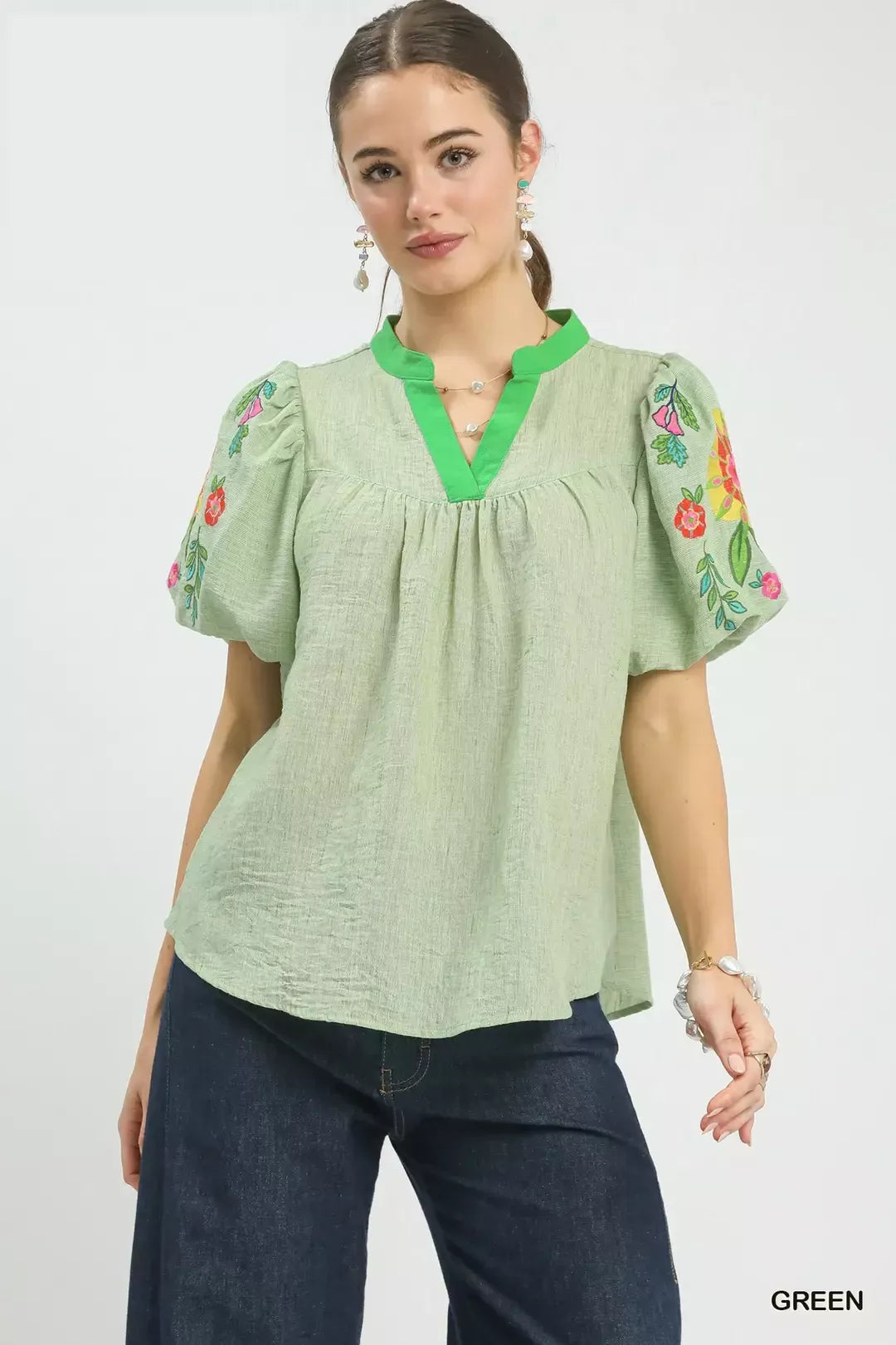 Light green puff-sleeve top with V-neck and floral embroidery on sleeves