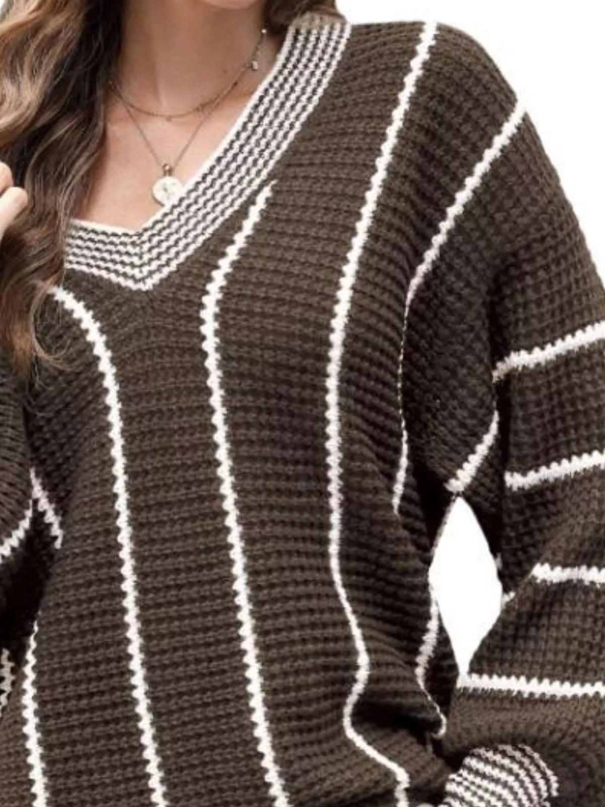 Brown V-neck textured knit sweater with white vertical stripe design and ribbed sleeve cuffs