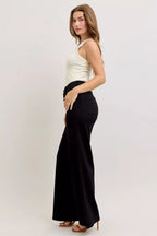 High-waisted wide-leg black denim jeans with back pocket detail, relaxed fit