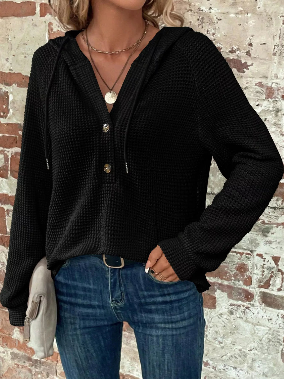 Black waffle-knit button hoodie with hood and drawstrings, relaxed fit front