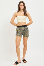 High-rise leopard-print shorts on model with black waistband and button closure