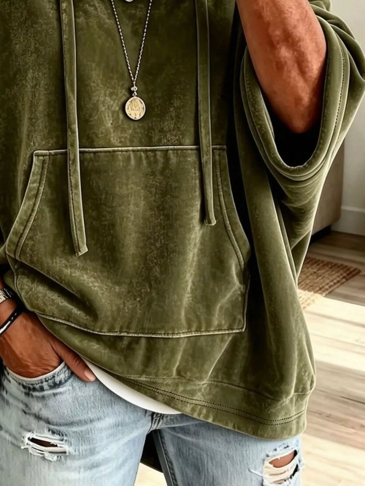 Olive velvet kangaroo pocket hoodie detail with drawstring ties and hood strings.