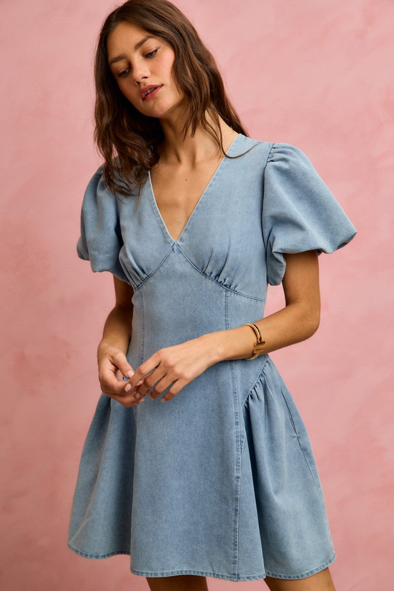Light wash denim mini dress with V-neck, puff bubble sleeves, and flared skirt