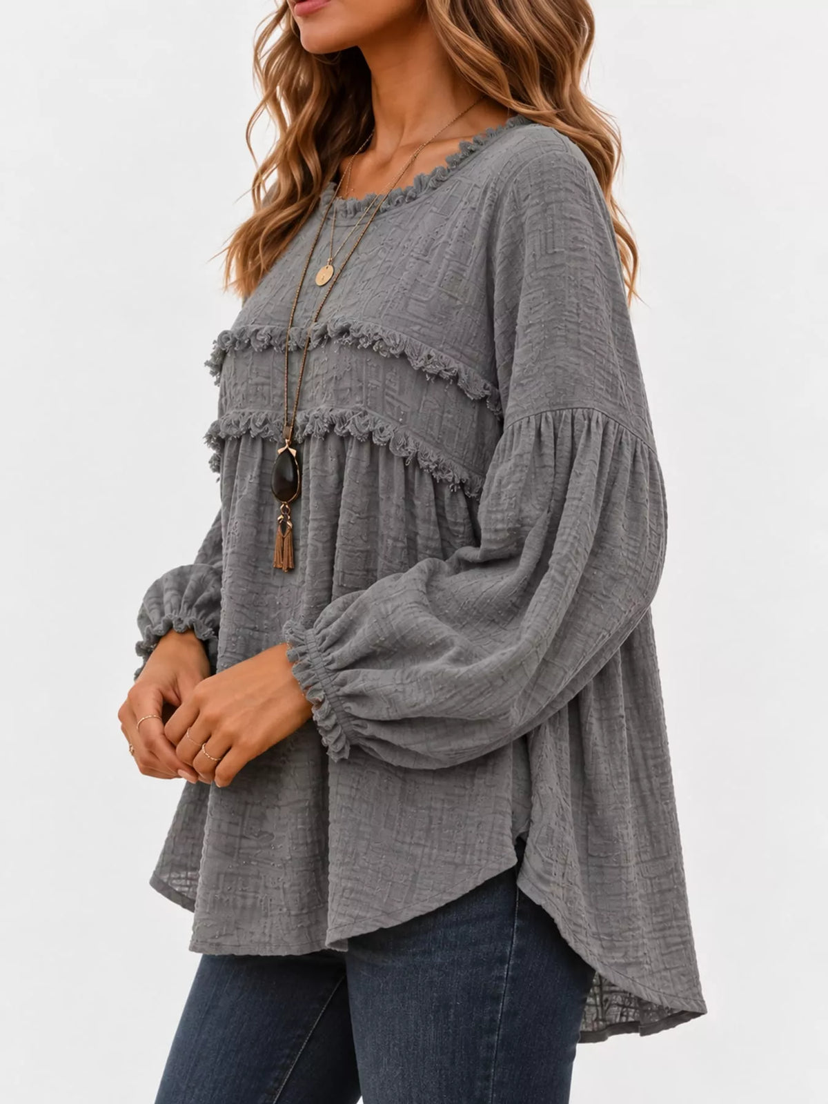 Gray frayed-trim peplum blouse with ruffle yoke and long puff sleeves, side view