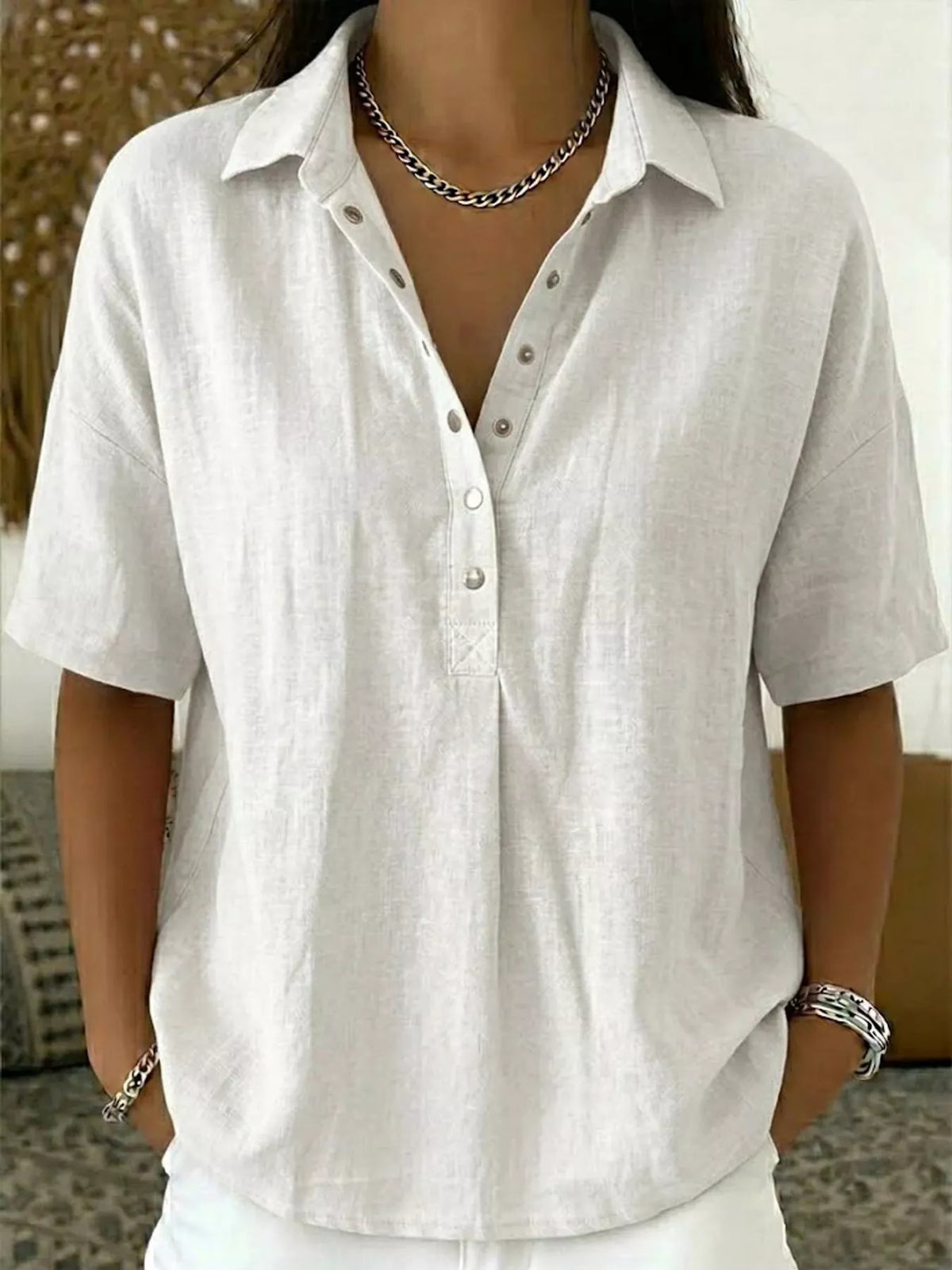 White short-sleeve snap-front shirt with collared neckline and button snaps