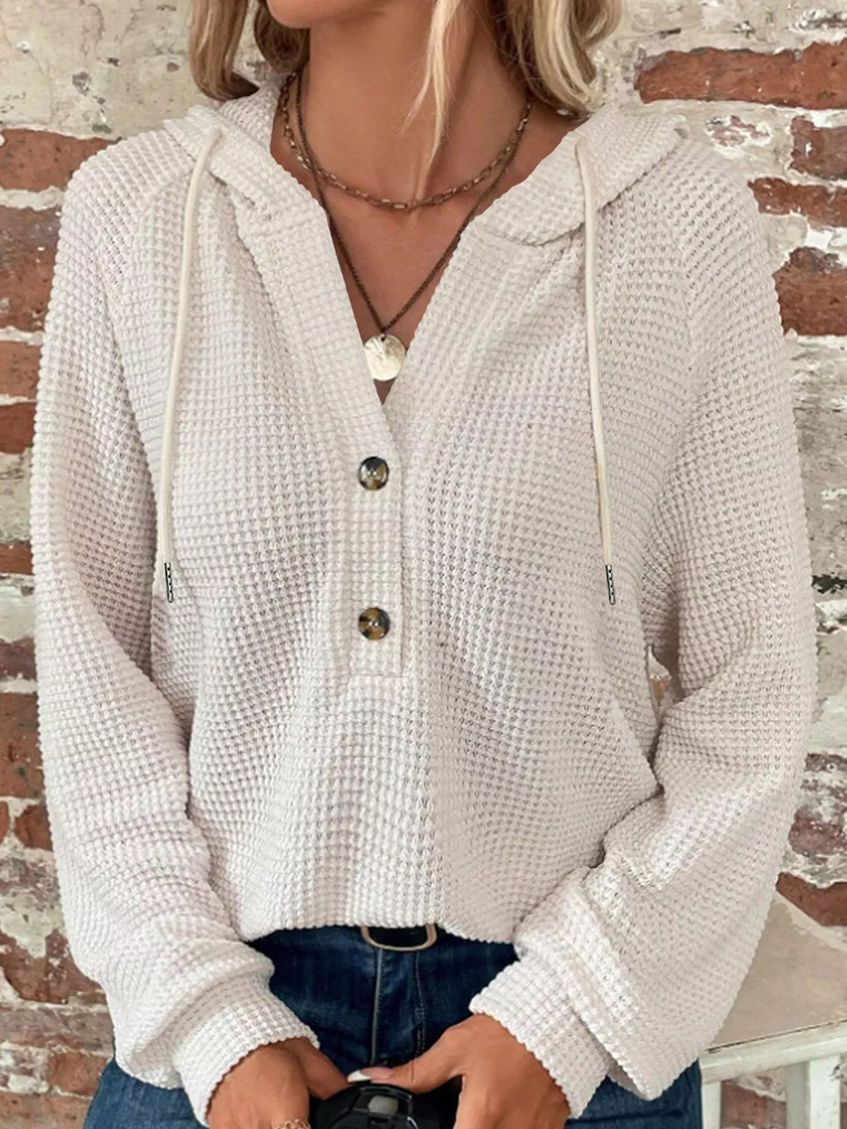 White waffle-knit button hoodie with hood, long sleeves, and front button placket.