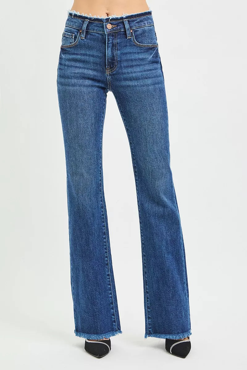 Women's mid-rise bootcut jeans in dark blue, back view with frayed waistband