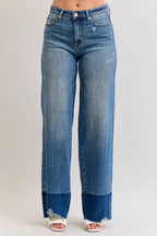High-waist straight jeans in medium blue denim, front view with raw hem