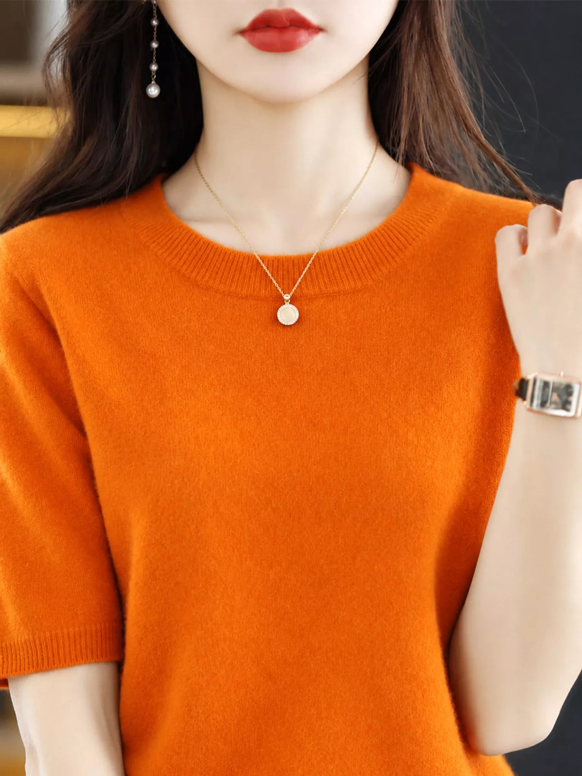 Bright orange round-neck short-sleeve sweater with ribbed crew neckline