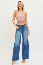 Women's medium-wash denim jeans, relaxed wide-leg baggy style, front pockets