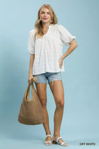 Off-white textured puff-sleeve blouse with V-neck, standing full view
