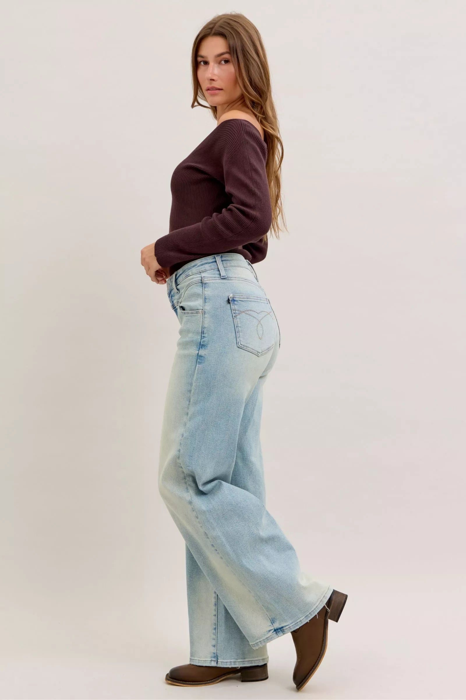 Light blue high-waist straight jeans back angle showing waistband, belt loops, and patch pocket
