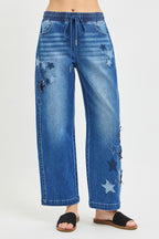 Medium-wash cropped barrel jeans with drawstring waist and star applique panels on legs