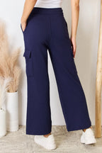 Dark blue drawstring cargo pants, wide legs, side flap pocket details