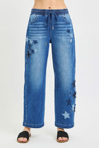 Cropped barrel jeans in medium-wash denim with elastic drawstring waist and star patches